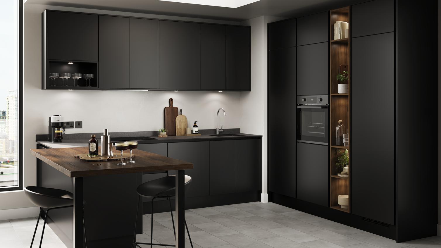 A kitchen with black cabinets and matching counter tops, including a dark wood-effect breakfast bar.